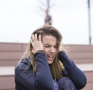 Portrait of angry young woman sitting at outdoor