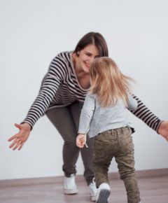 Happy loving family. Mother and her daughter child girl playing and hugging.